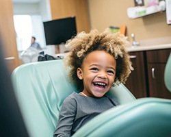 Laughing child in dental treatment chair
