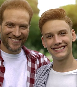 A dad and his son outside and smiling after seeing a kids dentist in Birmingham