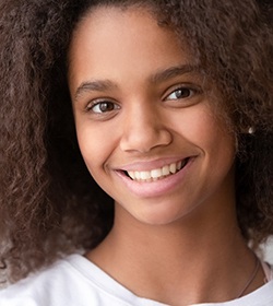 A female teenager smiling and showing off her perfectly straight and beautiful smile