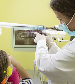 dentist pointing to digital x-rays