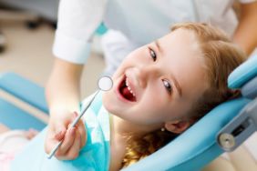 Happy little girl getting a dental exam