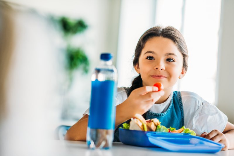 young girl eating healthy food