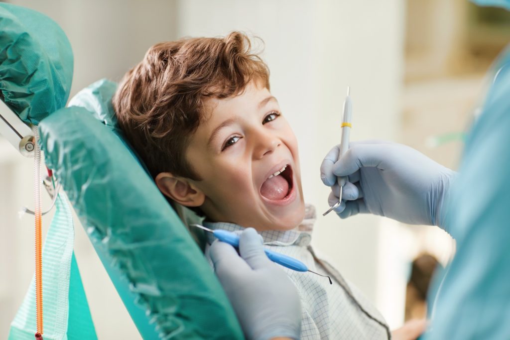 Child smiling while at dental checkup